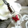 Sautoir bouteille vintage papillon rose